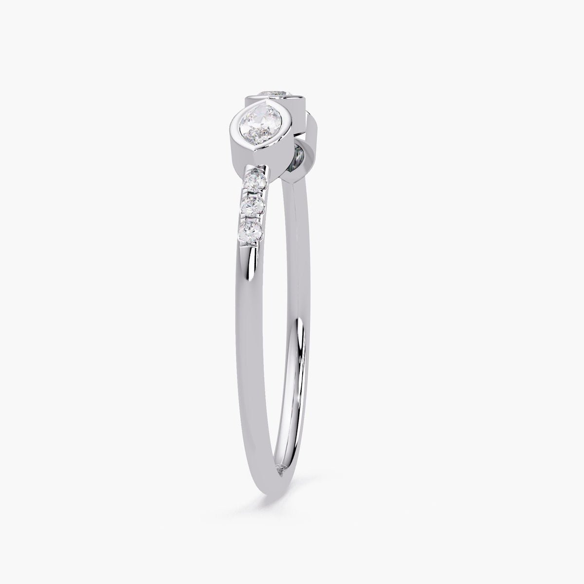 14K white gold ring featuring a marquise diamond set in a bezel setting with three small round diamonds on the side, shown from a side angle.