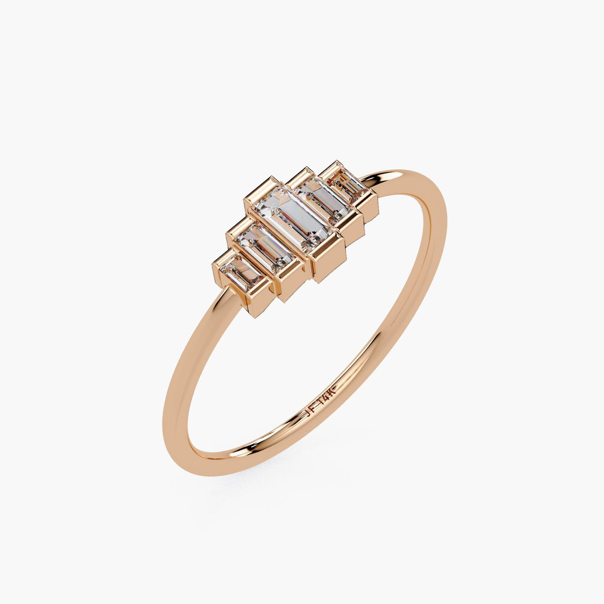 Angled view of a 14k rose gold ring with five step-set baguette lab grown diamonds in a geometric half bezel setting, showing the side profile and inner band engraving.