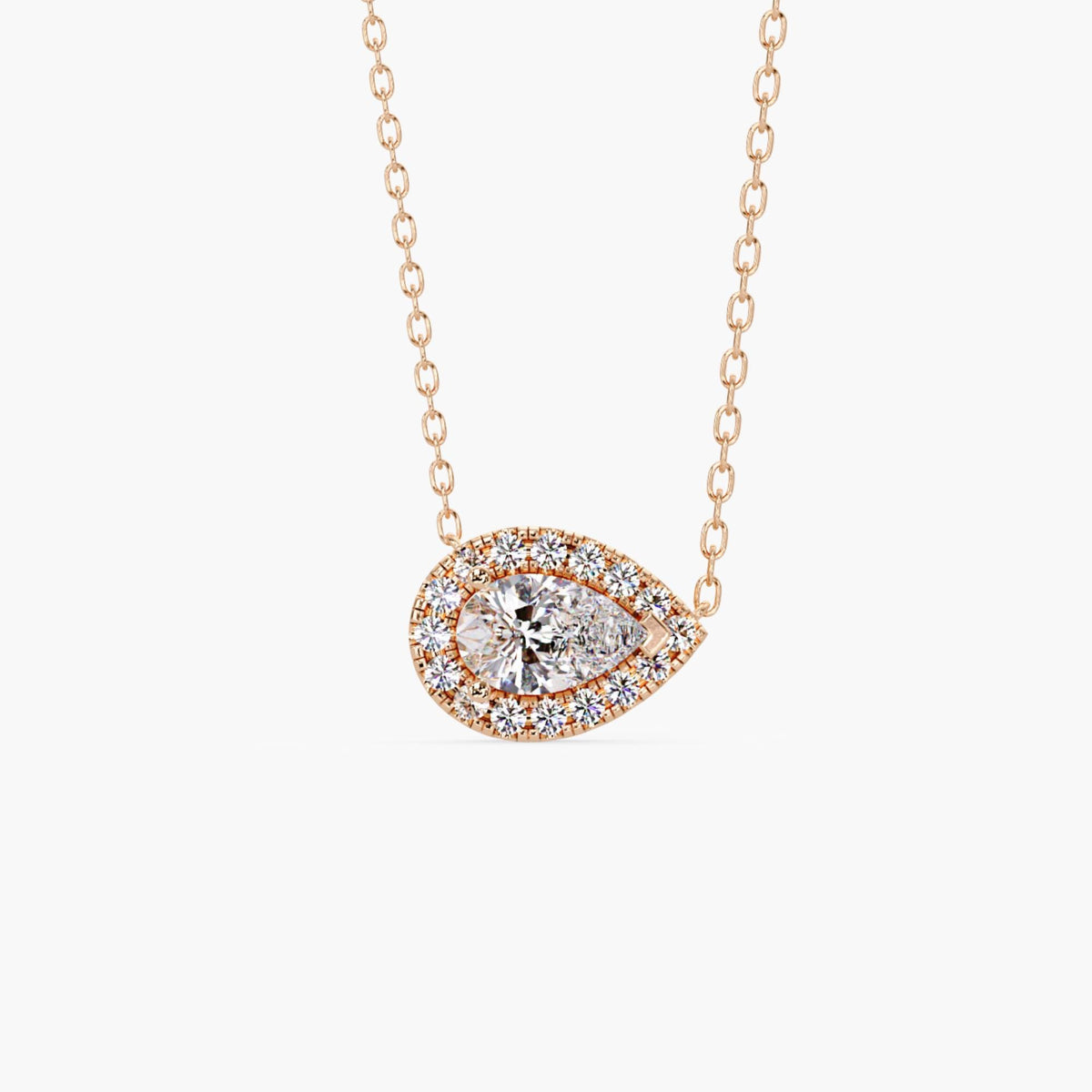 14k rose gold pear diamond pendant with a 1ct lab grown pear-shaped center diamond surrounded by a halo of round diamonds in an east west setting.