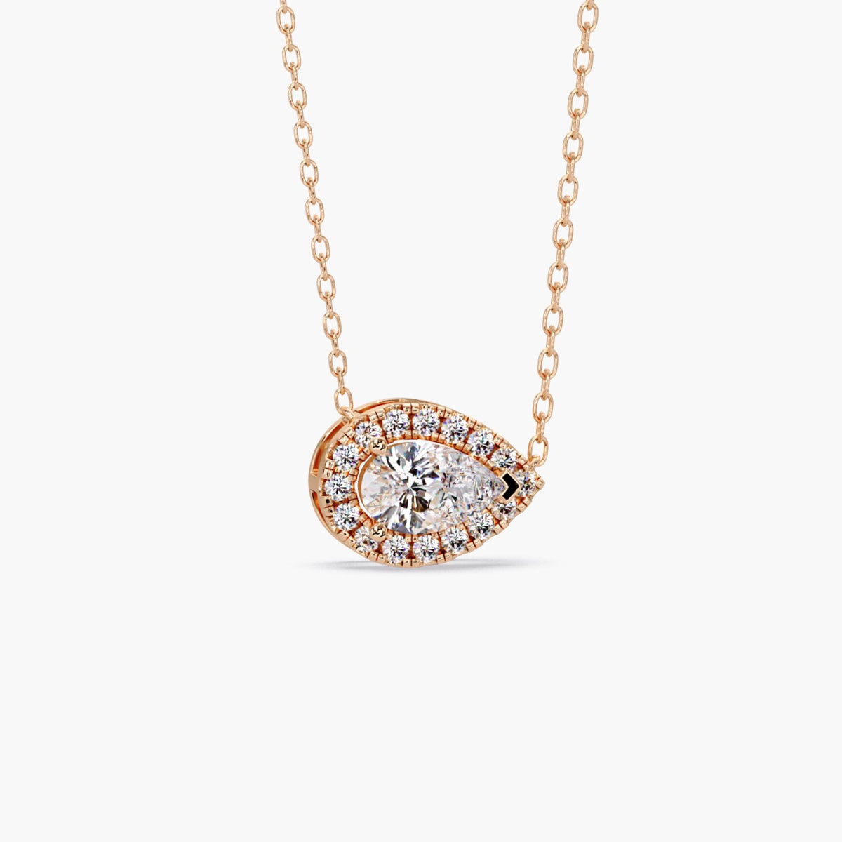 14k rose gold pear diamond pendant with a 1ct lab grown pear-shaped center diamond surrounded by a halo of round diamonds in an east west setting.