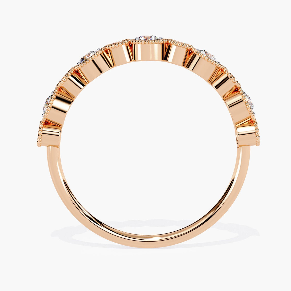 A side view of a rose gold band featuring alternating tapered and round diamonds set in a scalloped arrangement. The diamonds, encircled by delicate milgrain detailing, create a striking pattern along the top of the band, offering a modern yet vintage-inspired look.
