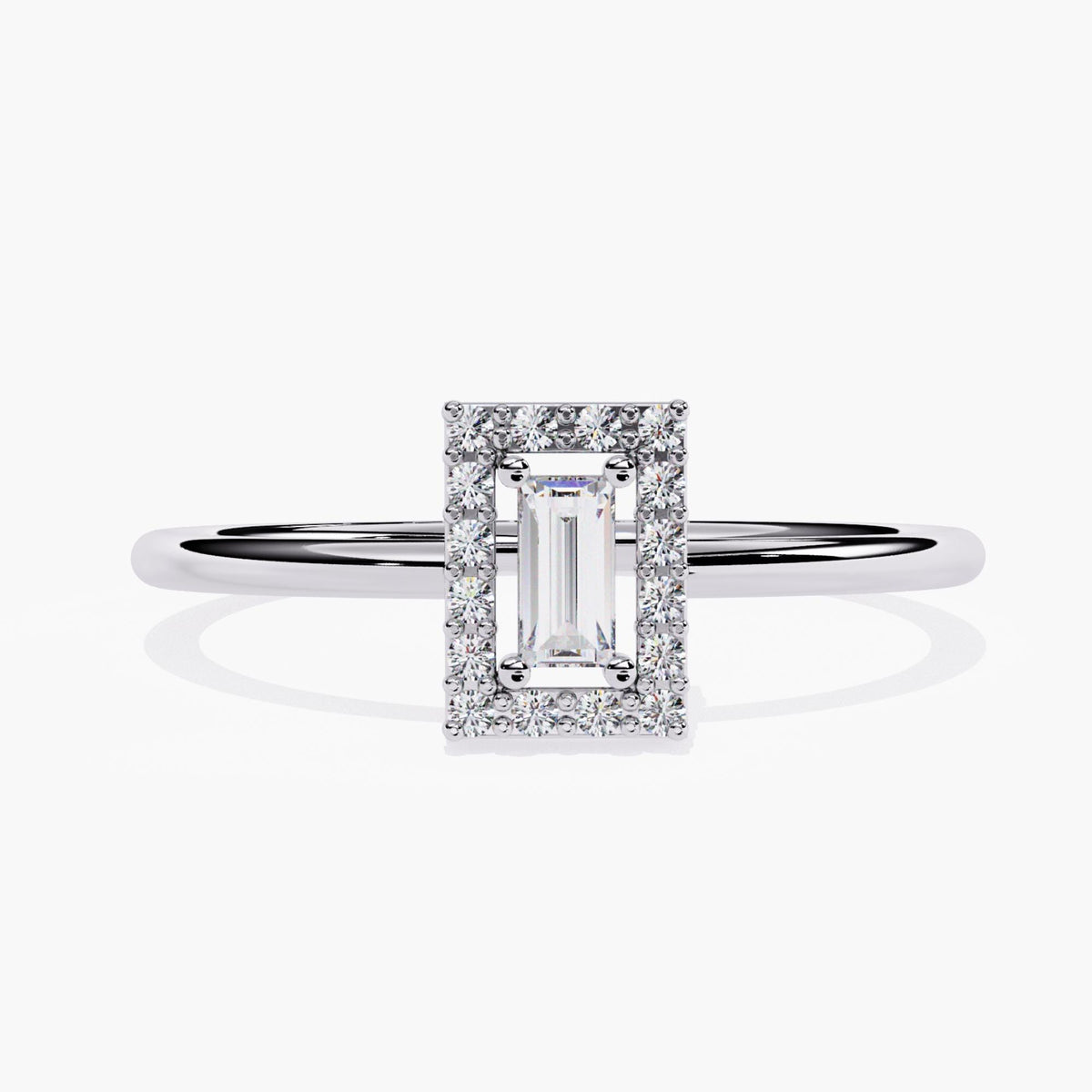 A white gold ring featuring a rectangular baguette-cut diamond at the center, encircled by a halo of round brilliant diamonds. The halo setting enhances the brilliance of the central stone, creating a striking contrast with the sleek polished band. The minimalist design offers a modern and timeless aesthetic, making this ring a perfect choice for an engagement ring or an elegant statement piece.