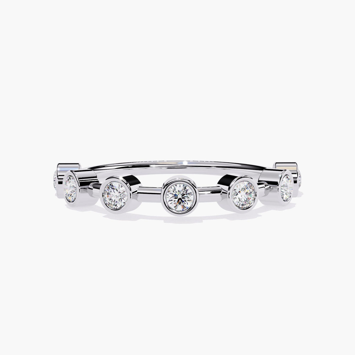 A white gold stacking ring featuring seven round diamonds, each set in a sleek bezel setting. The diamonds are evenly spaced along the band, creating a continuous, minimalist design. The polished band complements the diamonds, offering a modern, elegant look perfect for stacking with other rings or wearing alone. The clean, refined silhouette adds a touch of sophistication, making this piece ideal for daily wear or as a unique addition to any jewelry collection.
