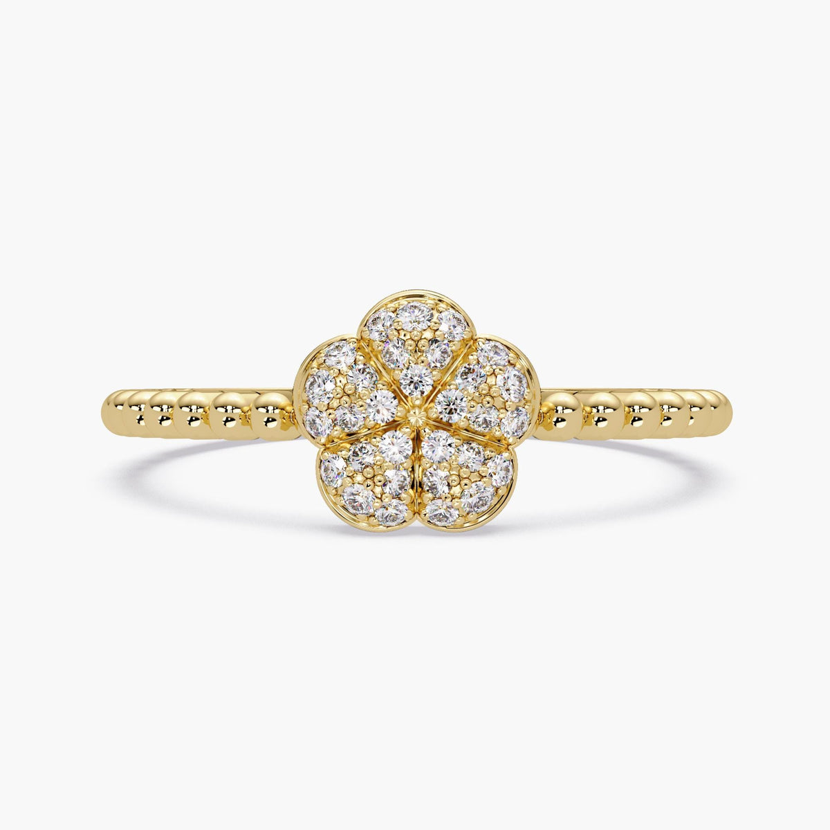 14k yellow gold diamond flower ring featuring 30 natural pavé-set round diamonds arranged in a five-petal floral cluster. The petals are softly domed and bordered in polished gold, creating a puffy, dimensional look. The band is slim with a beaded texture, adding contrast and detail to the delicate design.