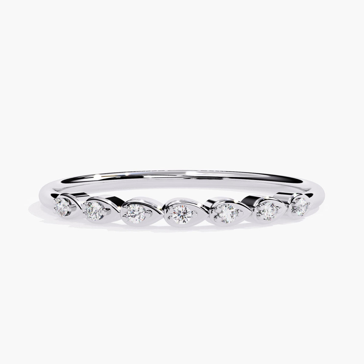 14k white gold diamond ring featuring seven round diamonds set in sideways pear-shaped bezels. The diamonds are evenly spaced along a slim polished band, creating a unique and delicate look ideal for stacking or wearing solo.