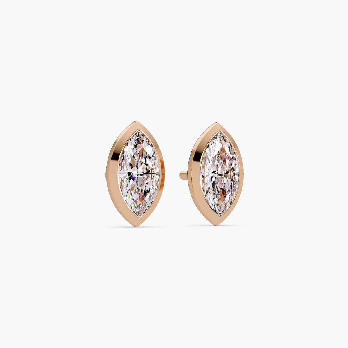 marquise cut lab grown diamond stud earrings in 14k rose gold. The bezel setting hugs each diamond with soft, warm tones, and the pushback post is partially visible. A sleek and feminine design for modern everyday wear or special occasions.