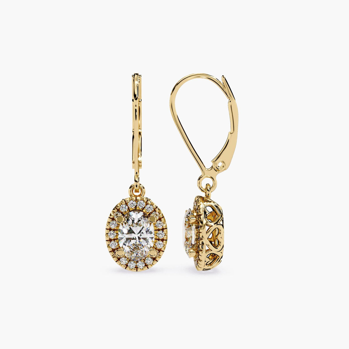 A pair of 14K gold leverback earrings featuring oval lab-grown center diamonds surrounded by a halo of round diamonds. The side view shows a heart-pattern filigree gallery, adding a romantic, vintage-inspired touch to the setting.