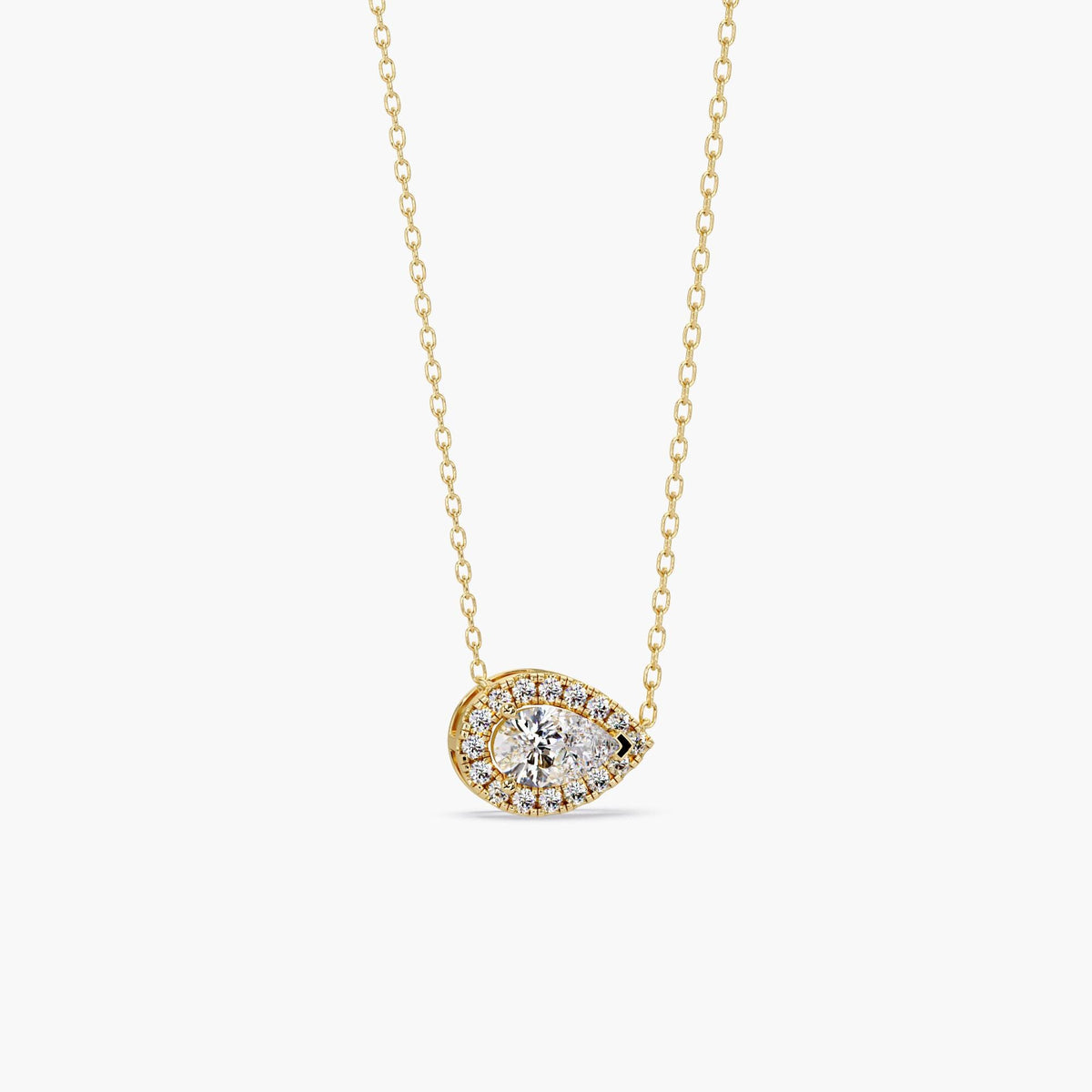 14k gold pear diamond pendant with a 1ct lab grown pear-shaped center diamond surrounded by a halo of round diamonds in an east west setting.