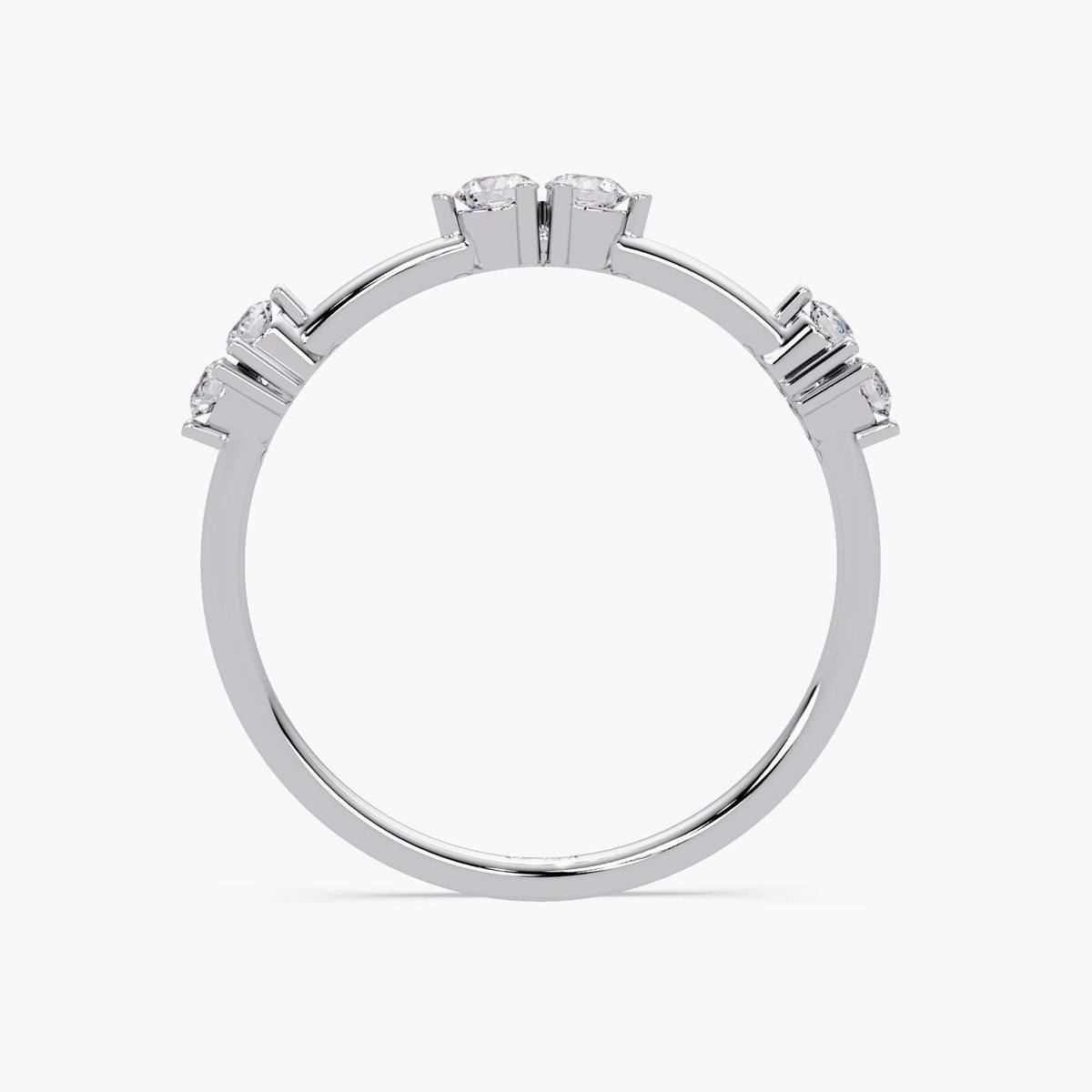 14K white gold stacking ring featuring six natural round diamonds arranged in three raised prong-set pairs. The diamonds are evenly spaced and sit elevated above a slim, polished band, allowing light to pass beneath each stone for enhanced brilliance. The band maintains a clean, minimalist curvature with a smooth finish, emphasizing the structured symmetry and refined craftsmanship of the design.
