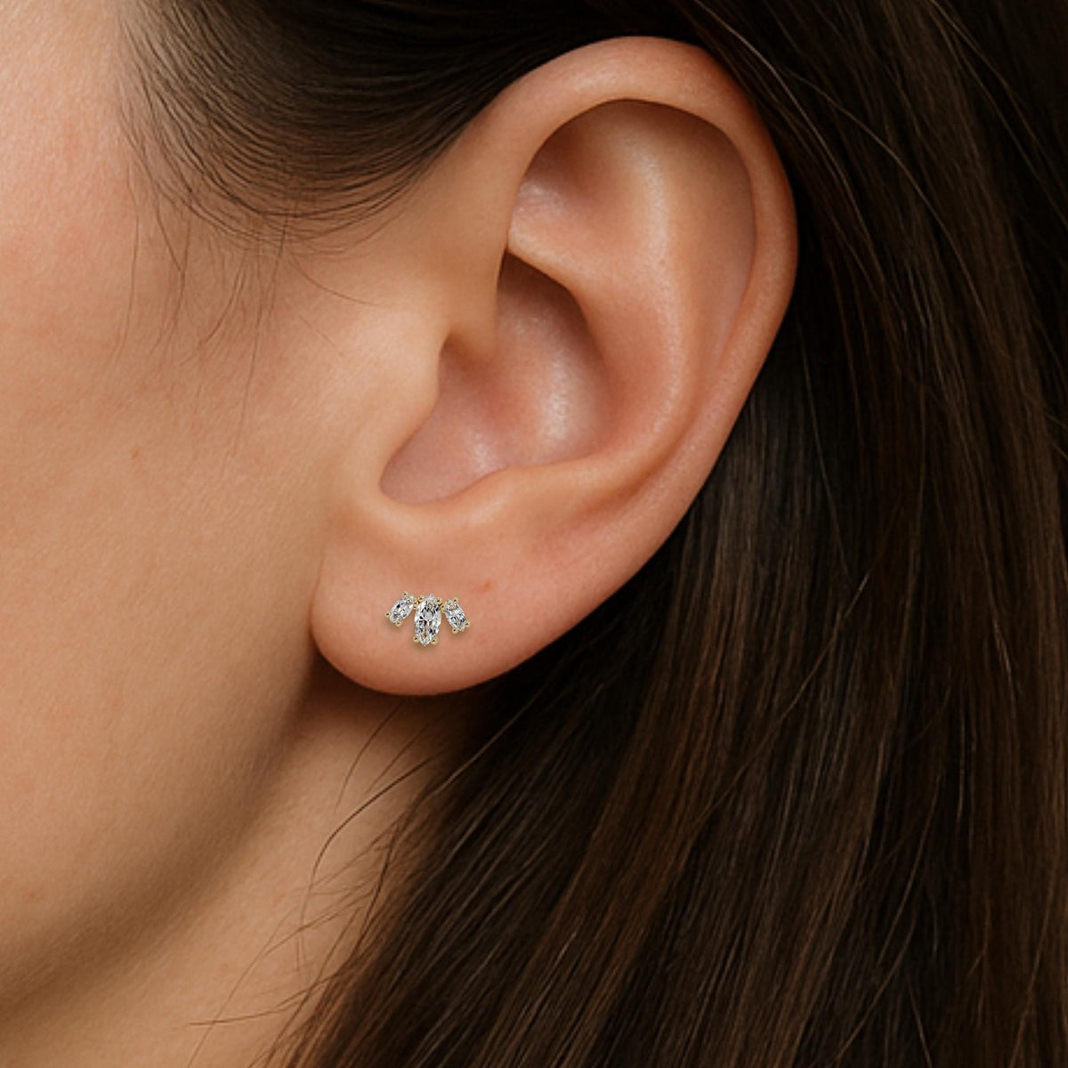 Model wearing dainty marquise flower stud earring shown worn in first piercing, 14K gold diamond earring suitable for gifting or minimalist styling