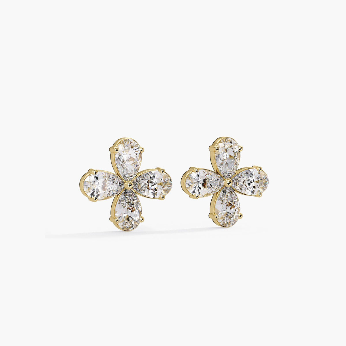 14K yellow gold flower stud earrings featuring four lab-grown pear-cut diamonds in each earring. The floral cluster design highlights the brilliance and symmetry of the diamonds in a modern prong setting.