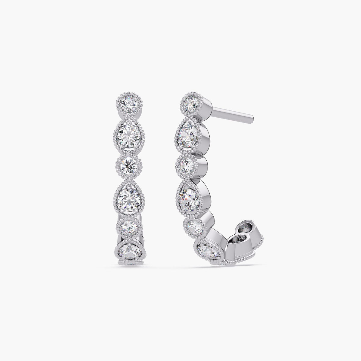14K white gold half hoop earrings featuring alternating round lab-grown diamonds in teardrop-inspired bezels. Each diamond is framed with intricate milgrain detailing. The design has a sculptural, Art Deco–inspired curve with EF color, VS+ clarity diamonds.