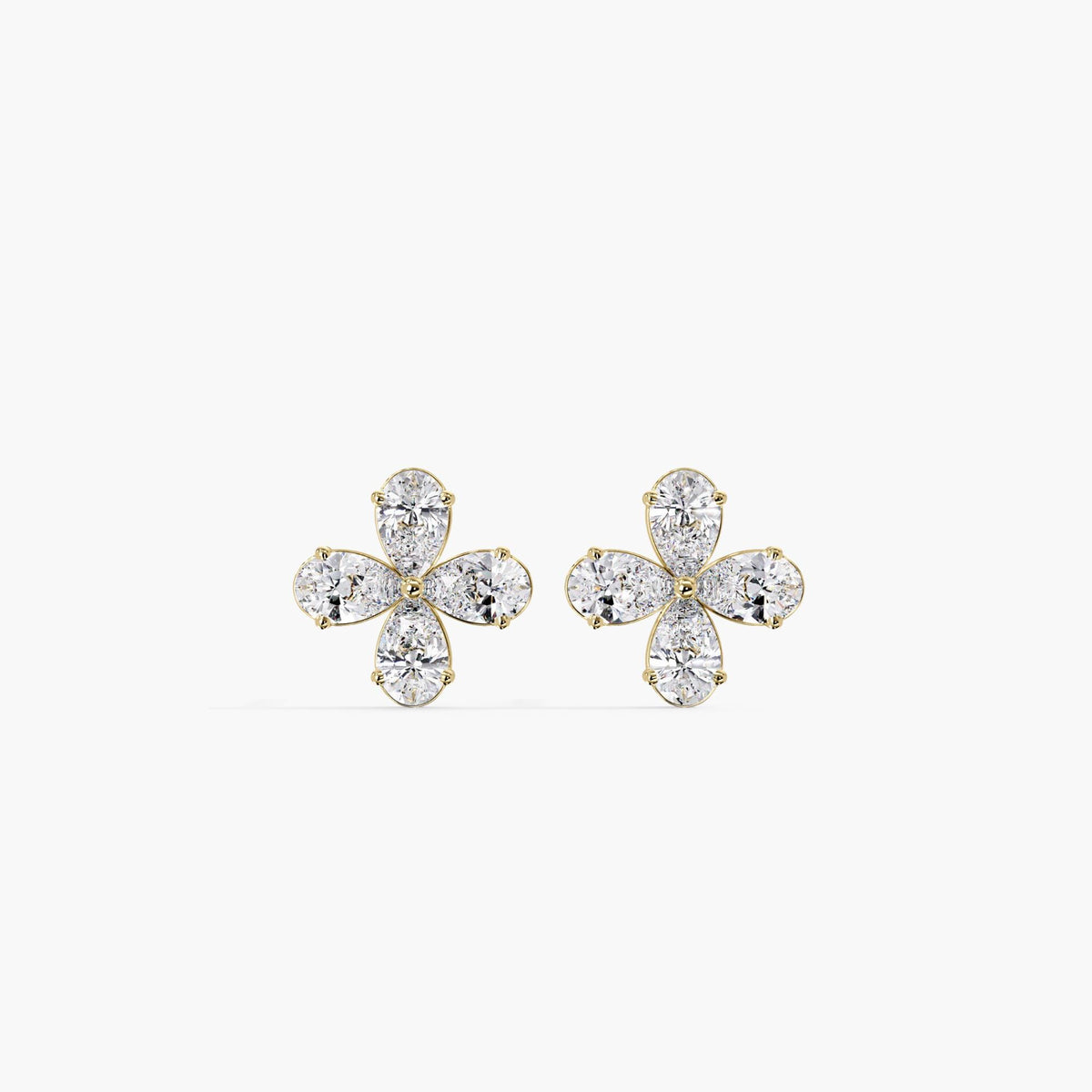 14K gold floral stud earrings featuring four lab-grown pear-shaped diamonds arranged in a daisy-like cluster. The dainty design is set in a yellow gold prong setting and reflects a minimalist, feminine style — ideal for everyday wear or gifting.