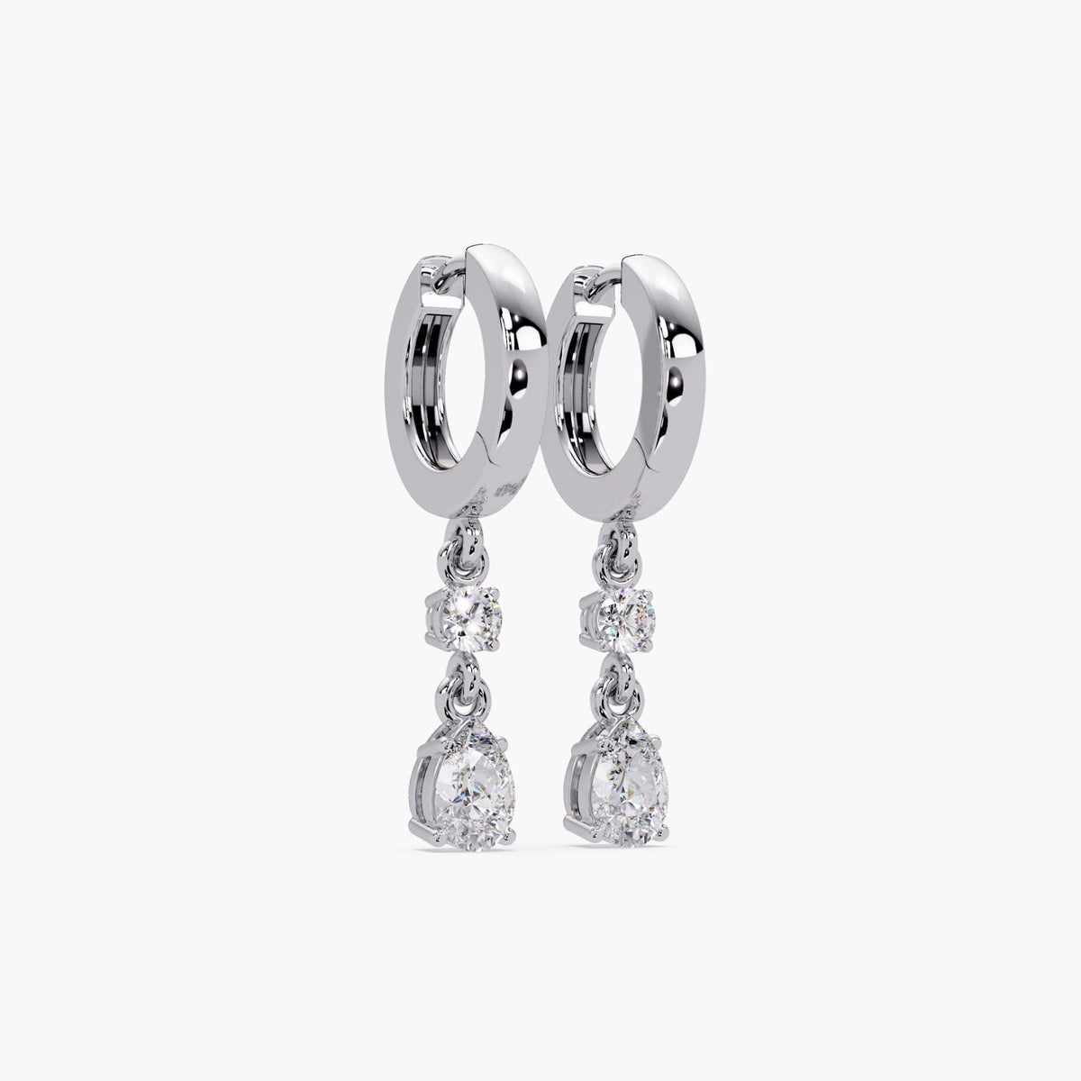 14K white gold huggie earrings featuring lab-grown round and pear-shaped diamonds in prong settings. Each earring has a 3mm round diamond and a 6x4mm pear diamond