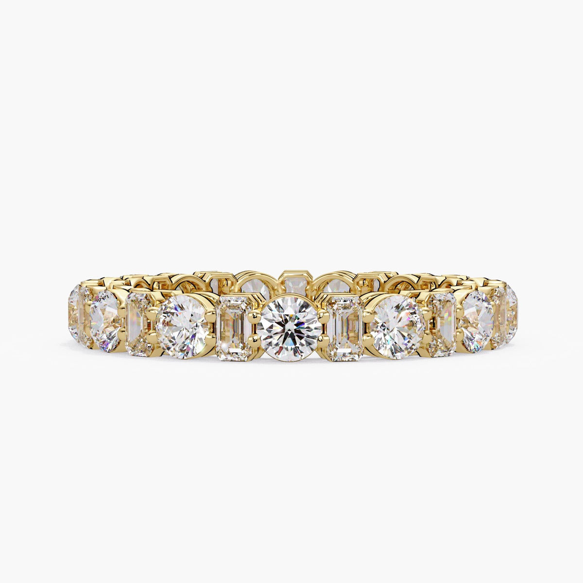14K yellow gold eternity ring featuring alternating prong-set round and emerald-cut lab-grown diamonds. Perfect as a wedding band, anniversary ring, or luxury stacking piece; ideal for bridal styling or milestone gifting
