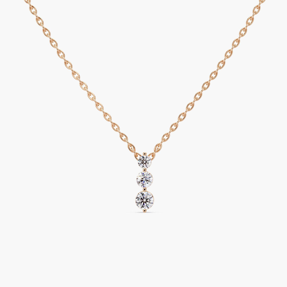 three-stone diamond pendant in 14K rose gold, featuring graduating round lab-grown diamonds on a fine cable chain