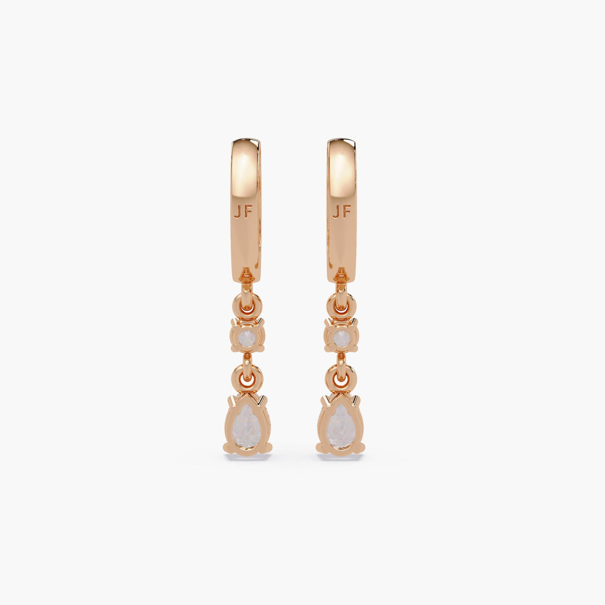 14K rose gold huggie earrings showcasing secure basket settings for round and pear-shaped lab-grown diamonds. Engraved with “JF” branding on the hoops. Designed for long-term wear
