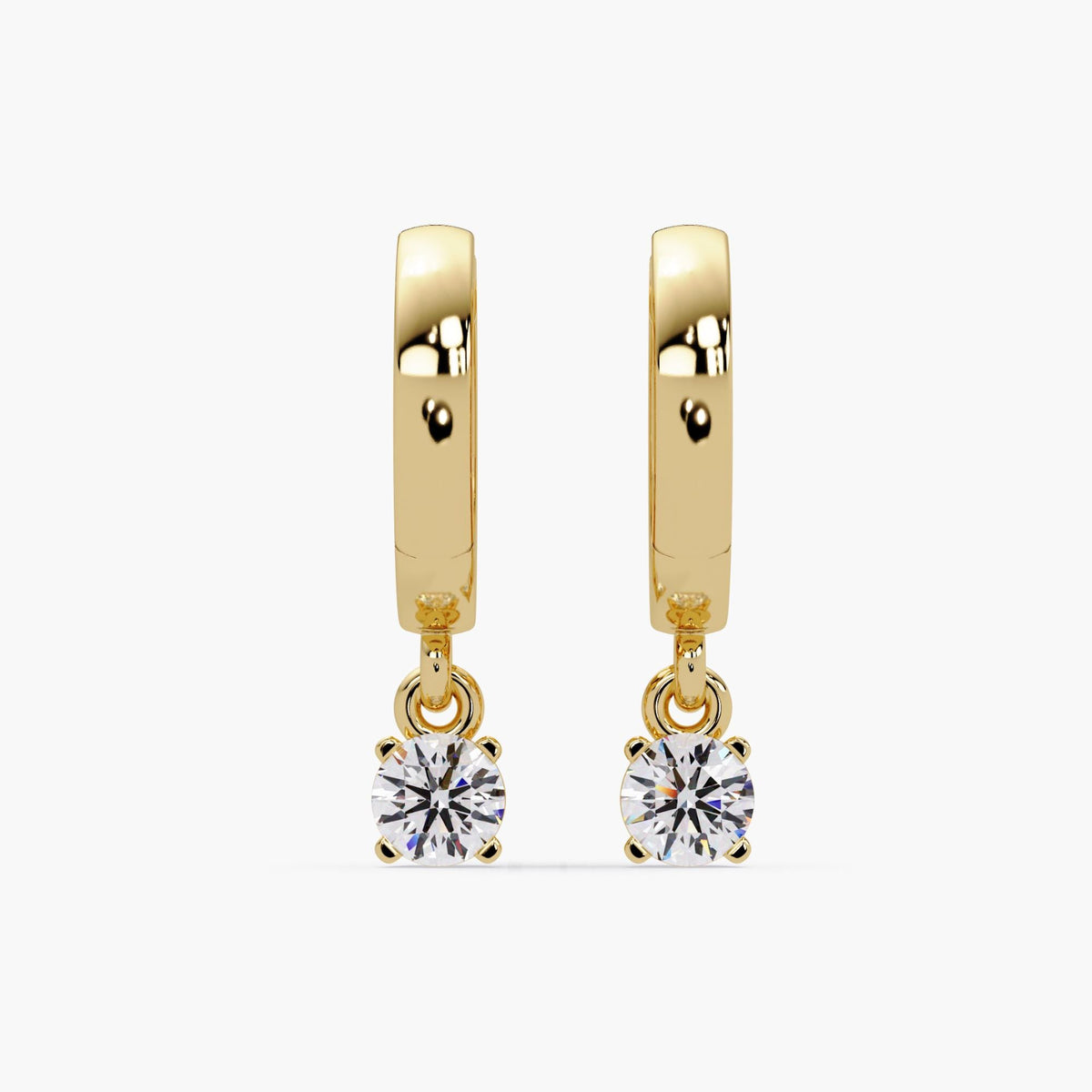 Pair of 14K yellow gold huggie hoop earrings with round lab-grown diamond drops in four-prong settings. Hinged latch back closure