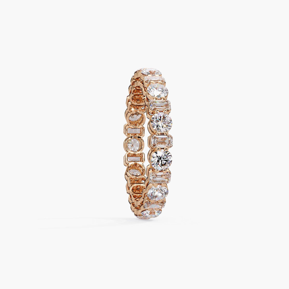 14K rose gold eternity band featuring alternating emerald-cut and round-cut lab-grown diamonds in a modern bezel and prong setting.
