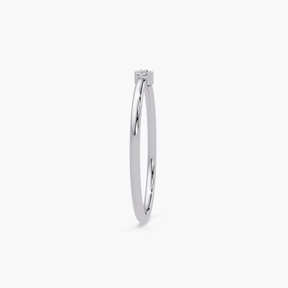 14K white gold ring with a single center diamond set on a slim high-polish band, showing ultra-thin profile and minimalist setting