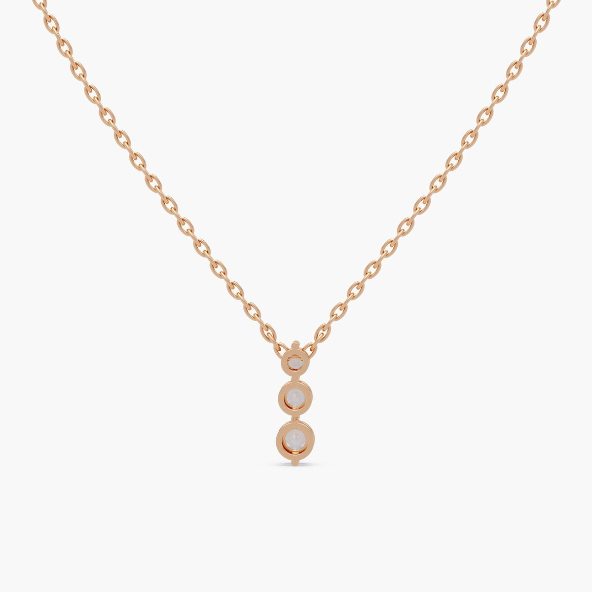 14K rose gold diamond pendant necklace showing bezel settings and polished finish