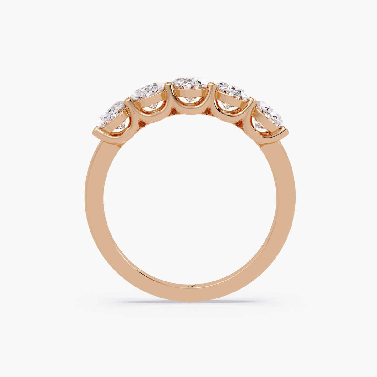 five stone oval diamond half eternity ring in 14K rose gold, showing open prong gallery for maximum light reflection and brilliance.