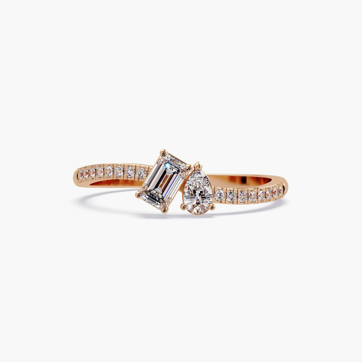14K rose gold toi et moi ring with emerald cut and pear cut lab diamonds on pavé diamond band, modern two stone bypass engagement ring design