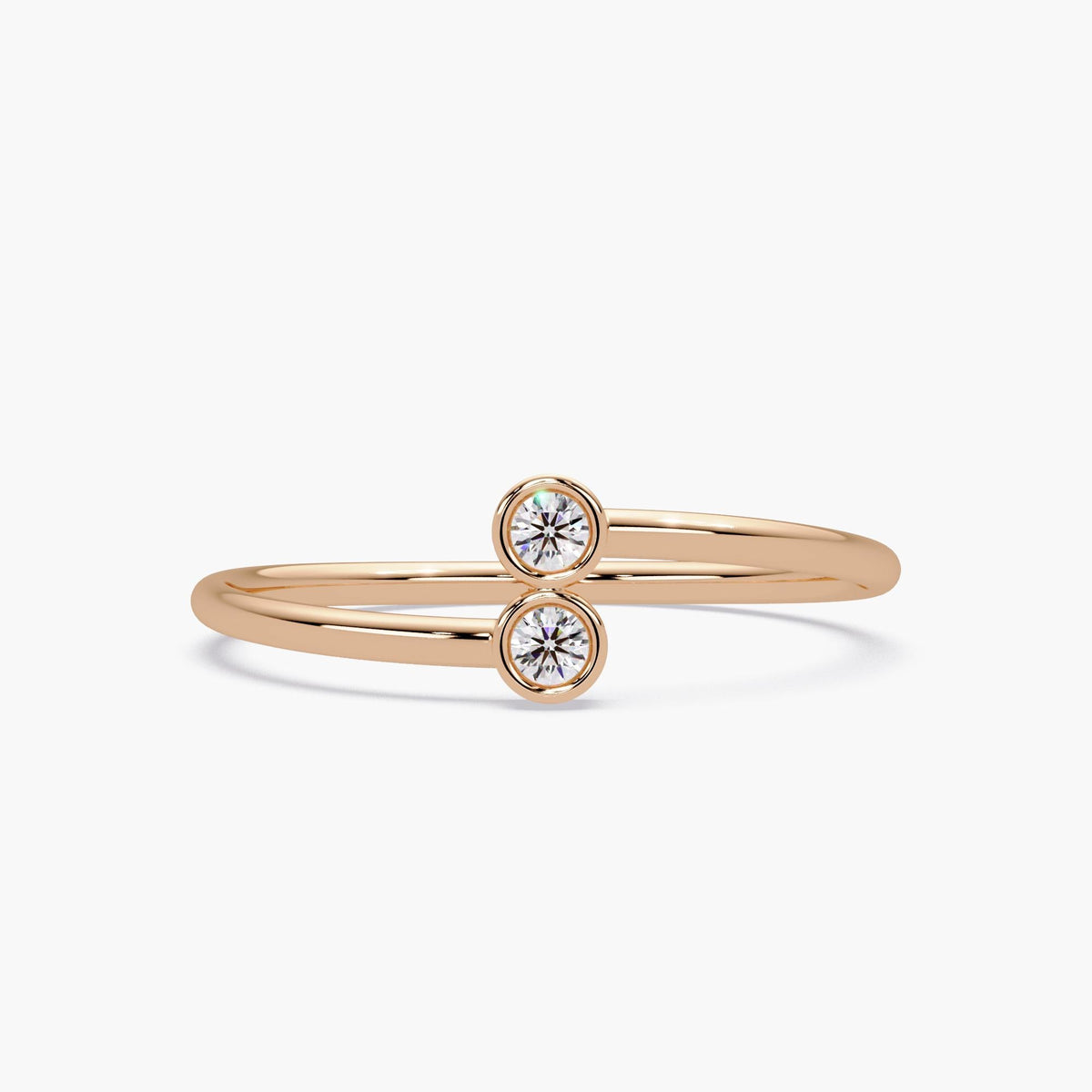 14k white gold bypass ring with two bezel set natural diamonds.