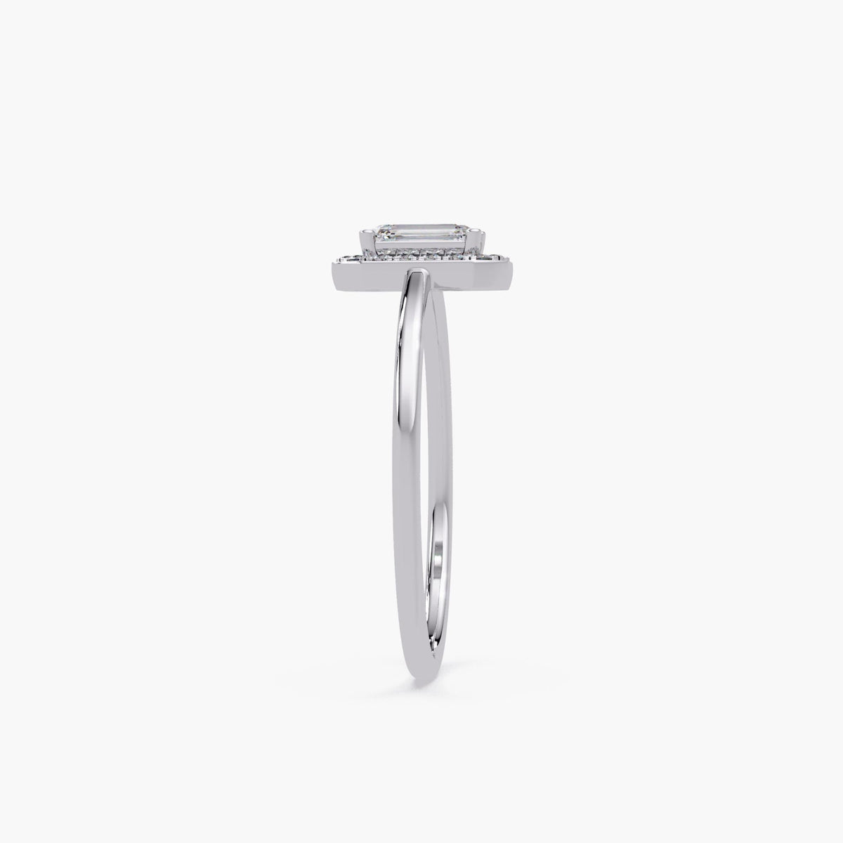 slim white gold diamond halo ring with raised emerald-cut center, showing band thickness and low-profile setting