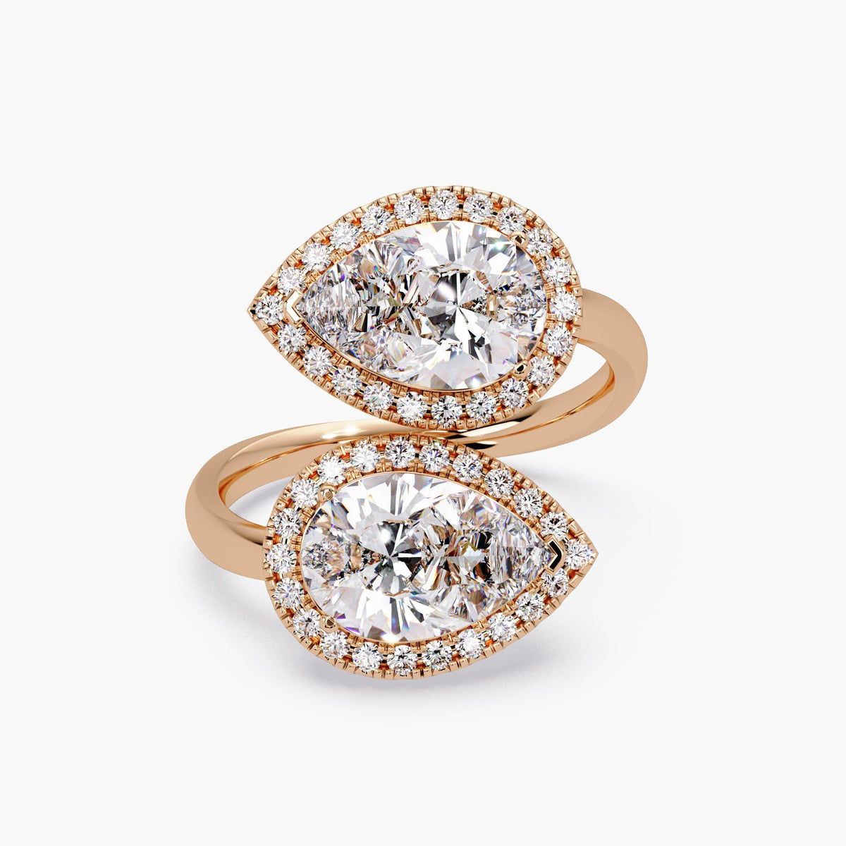 Double pear-shaped halo ring in 14K rose gold featuring IGI certified 1.5 CT diamonds in bypass setting with pavé accents.