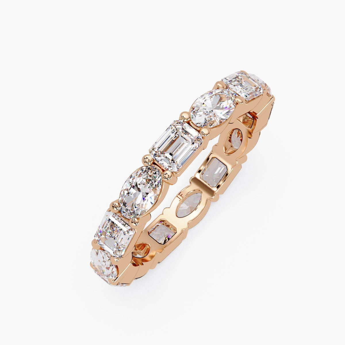 14k gold eternity ring with oval and emerald cut stones.