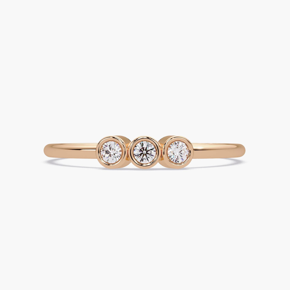 14k gold three stone diamond ring with bezel set natural diamonds.