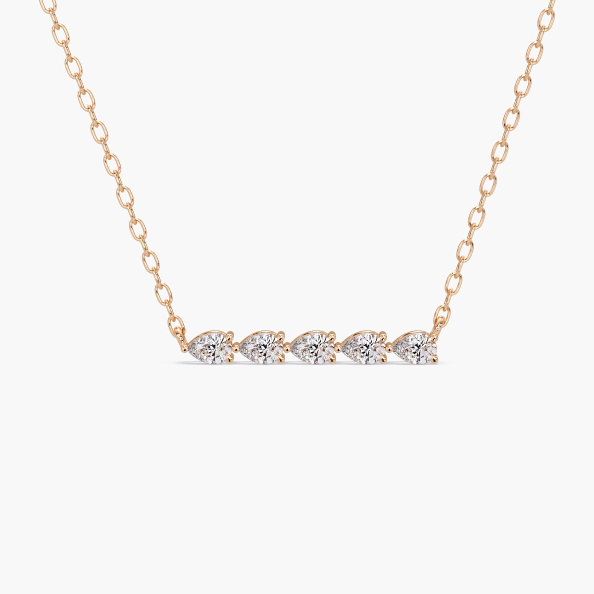 pear diamond bar necklace in 14k rose gold, featuring five lab-grown pear cut diamonds set in a horizontal row. Each diamond is prong-prong set, forming a delicate and symmetrical bar pendant attached to a fine chain. Ideal as a layering necklace or a minimalist gift.