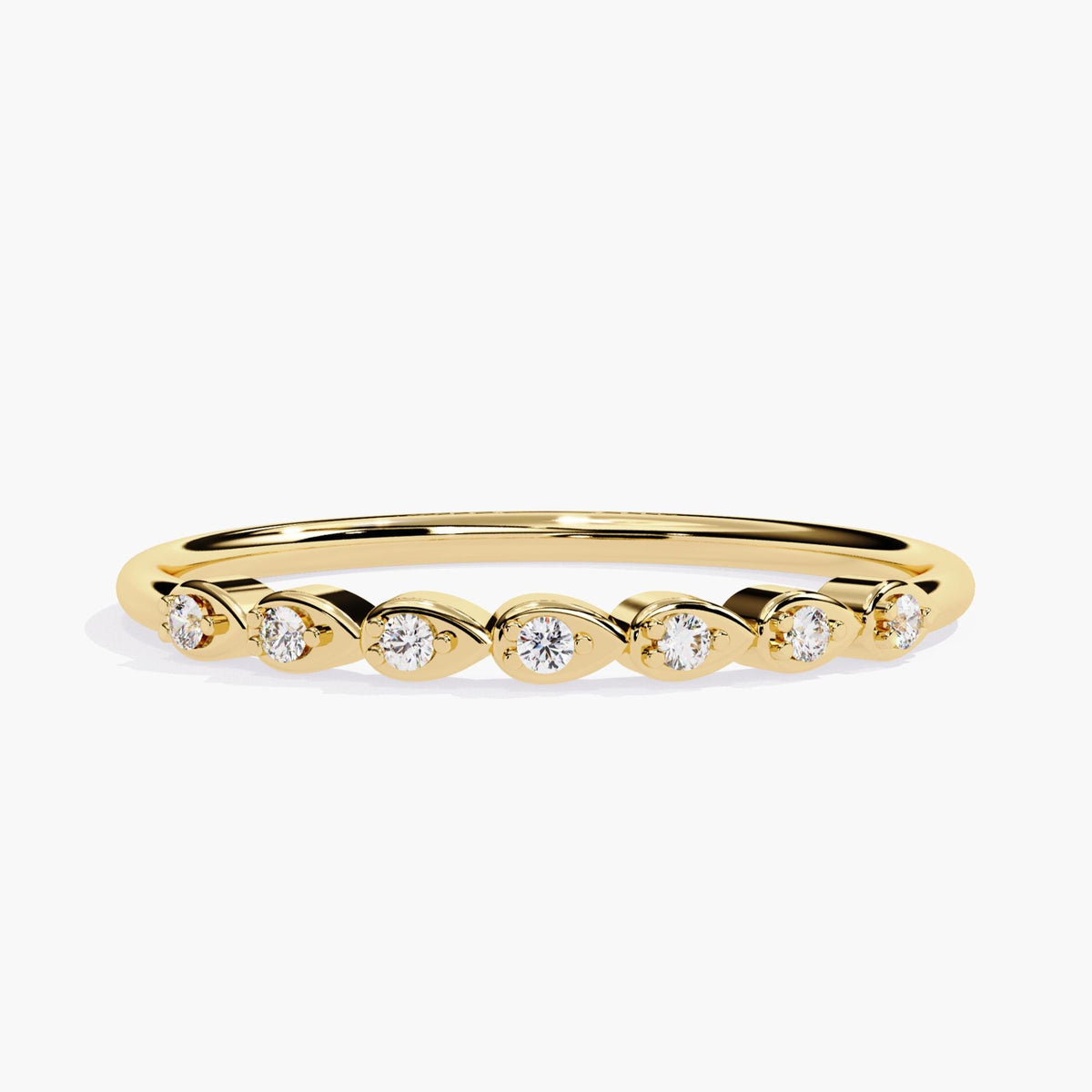 A 14k yellow gold band featuring seven natural round diamonds, each set in a sideways pear-shaped bezel. The sleek and dainty design makes it a unique choice for stacking, everyday wear, or as a seven-stone anniversary or milestone ring.