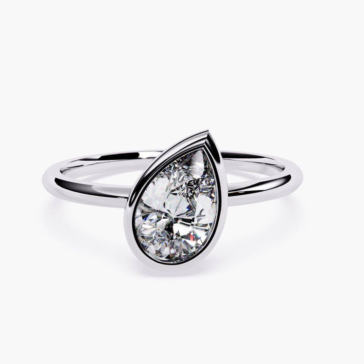 A white gold ring with pear cut diamond at the center.
