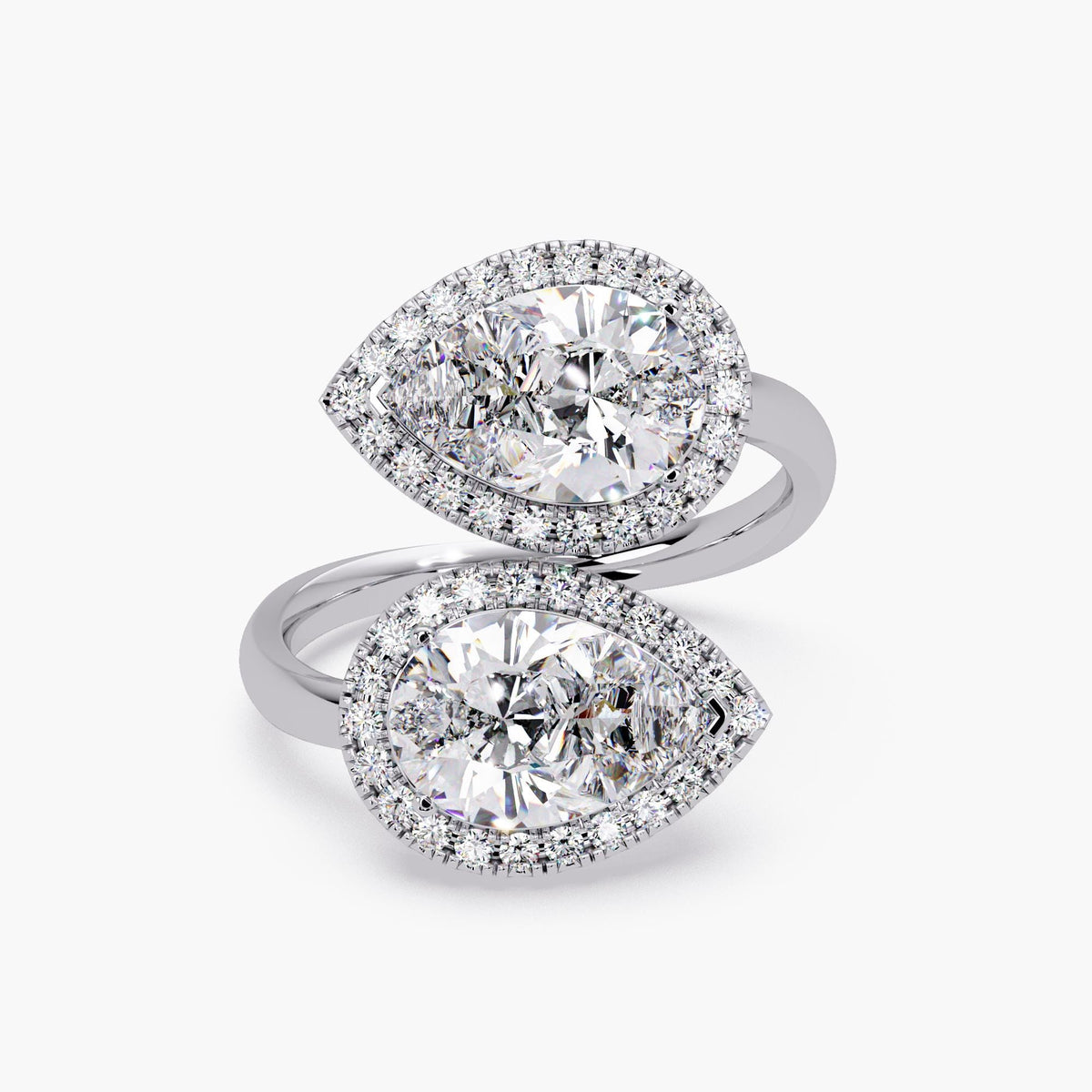 14K white gold Toi et Moi bypass ring featuring two IGI-certified pear-shaped lab-grown diamonds with pavé halos in a sculptural open band design.