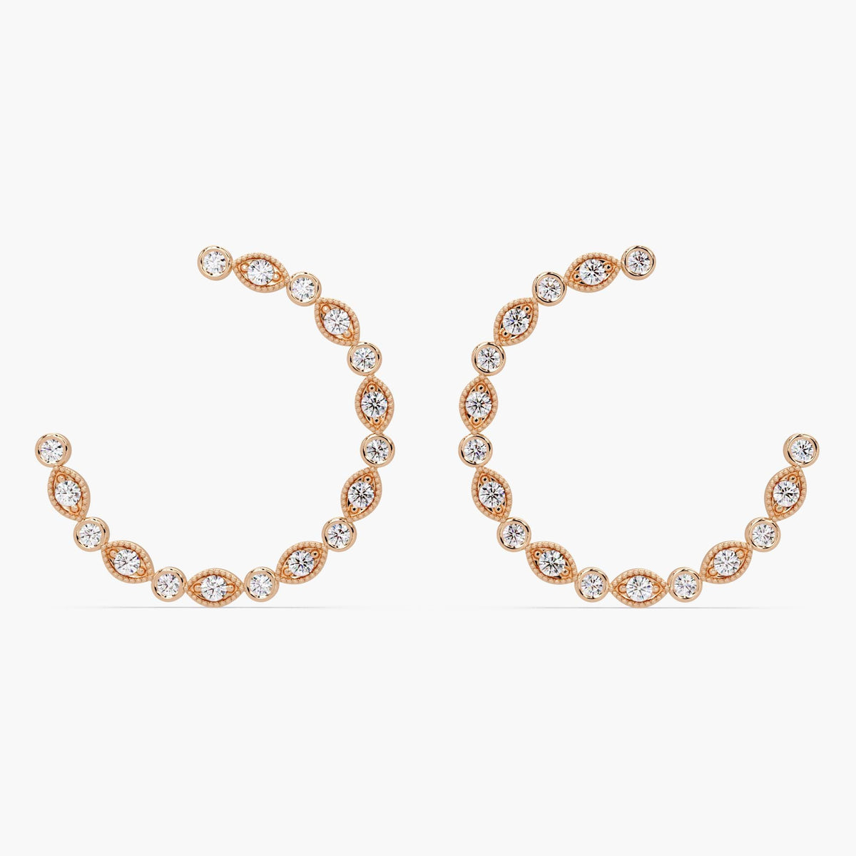 Pair of gold diamond hoop earrings with pave and bezel setting.