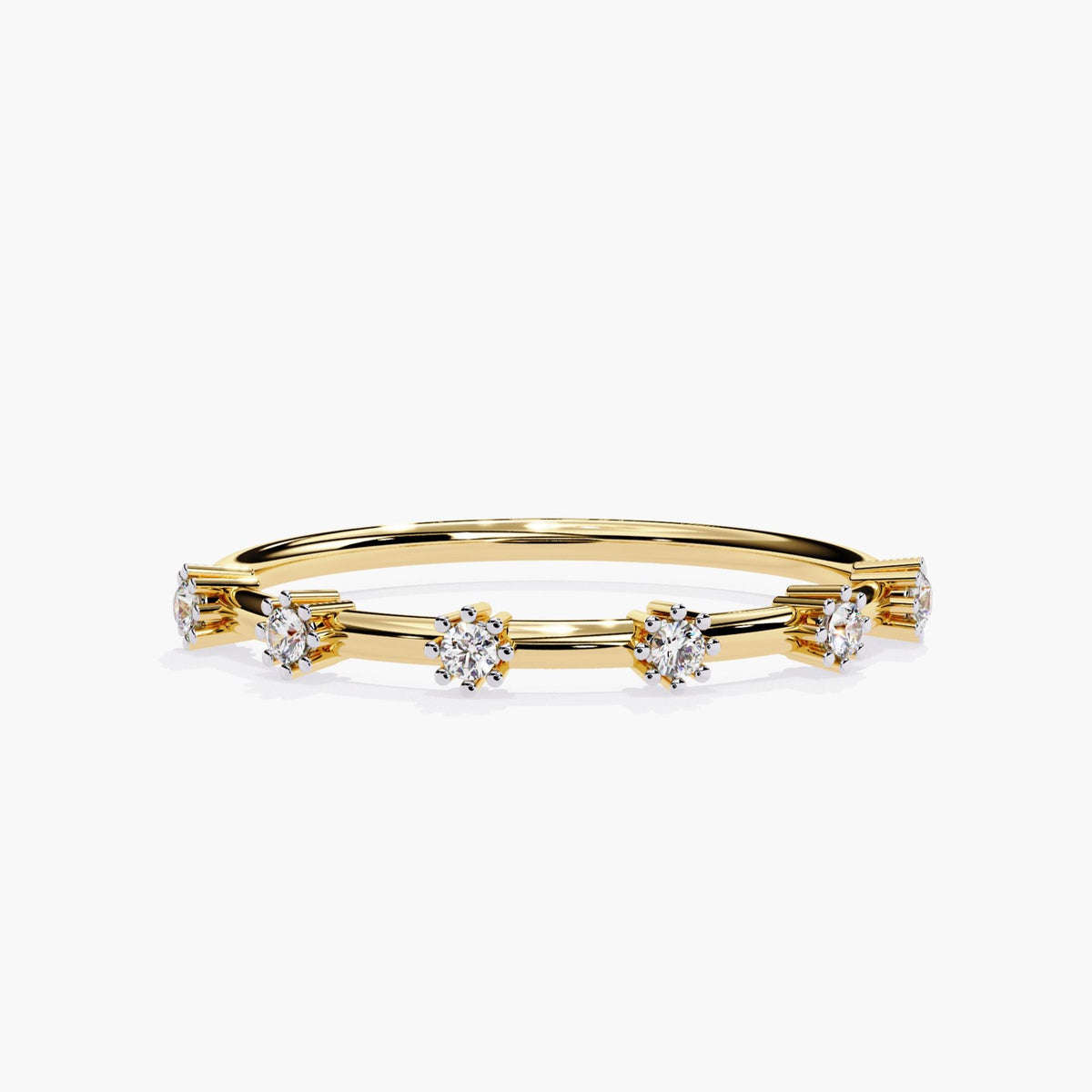 A slim 14k yellow gold band with six evenly spaced round natural diamonds in prong settings. The diamonds appear to float above the band, creating a modern distance ring design. Each diamond is set in a minimal claw-style mount, allowing light to pass through for added sparkle.