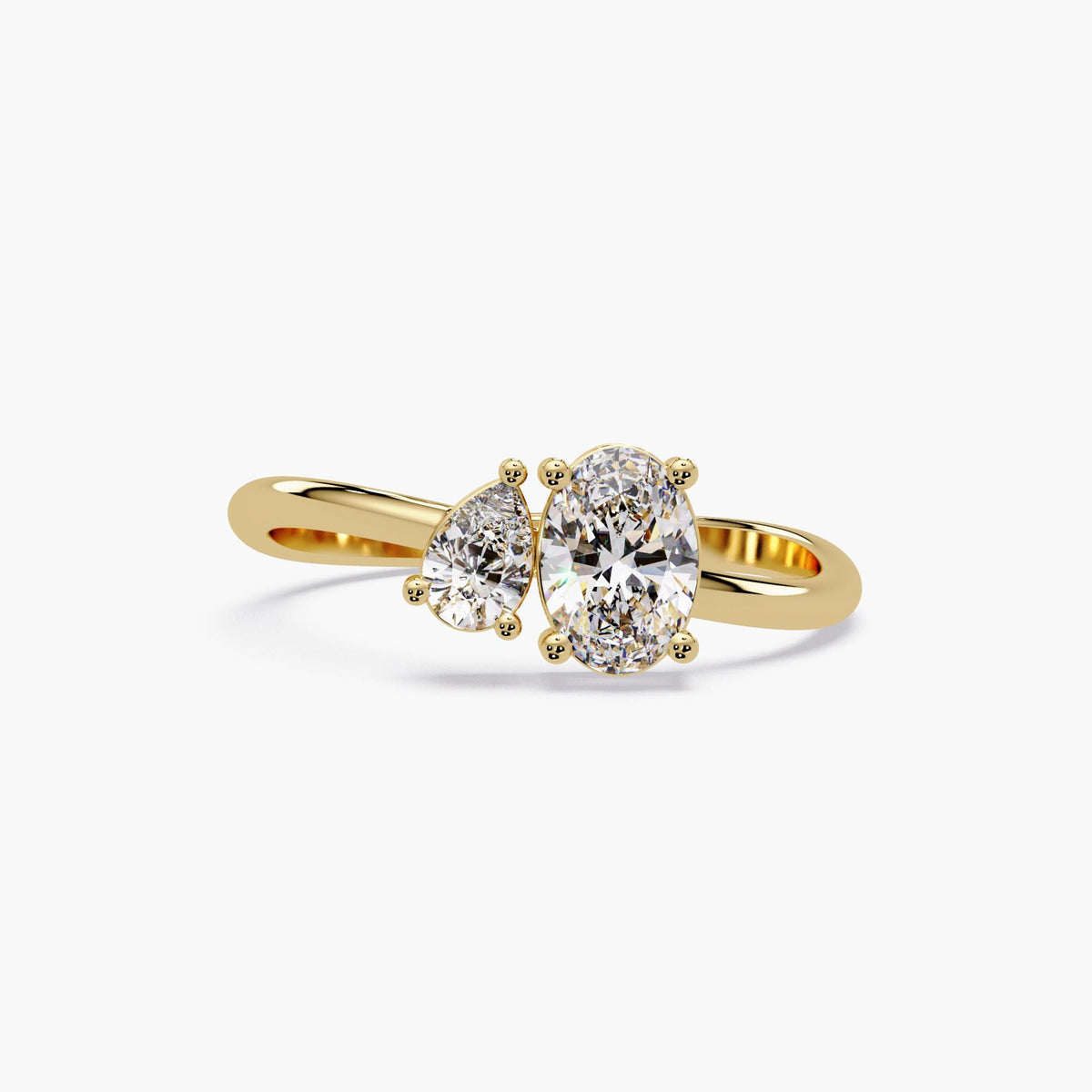 14K yellow gold two-stone ring with pear and oval lab-grown diamonds in an open offset band, Toi et Moi style.