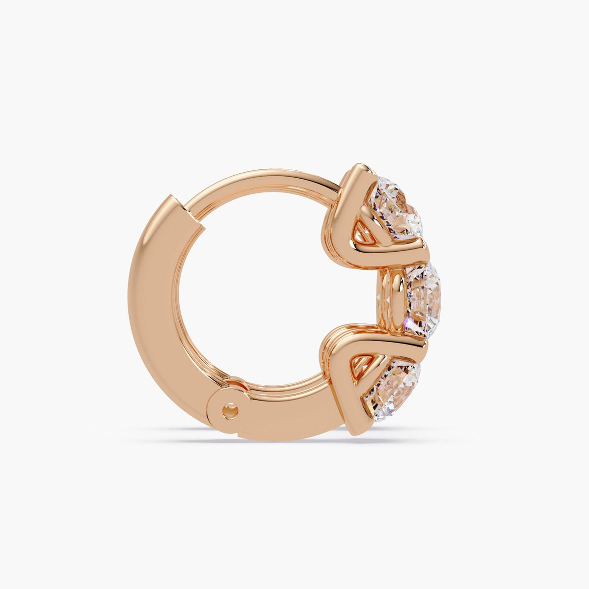 side view of round diamond prong setting on gold hoops