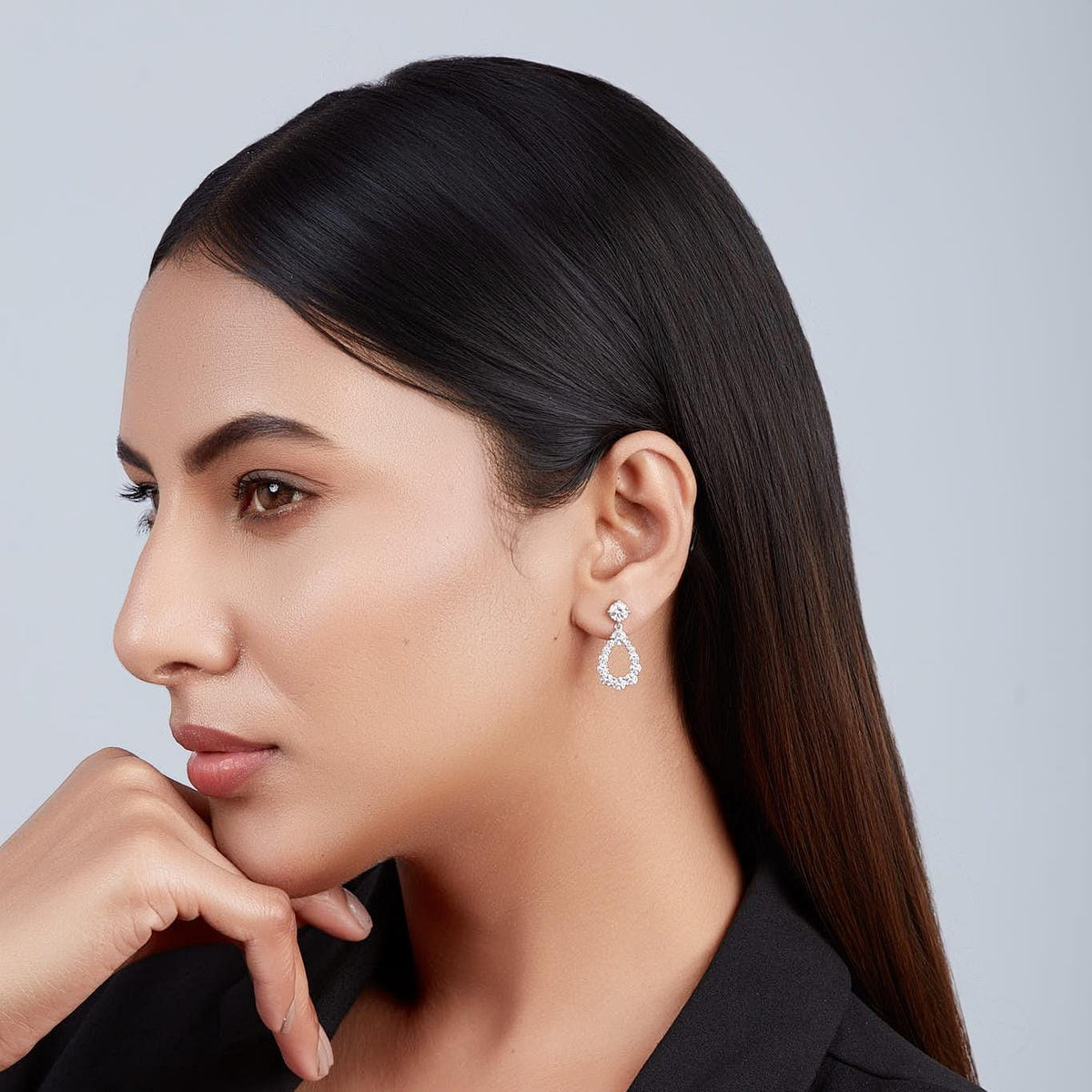 Model wearing gold teardrop diamond earrings