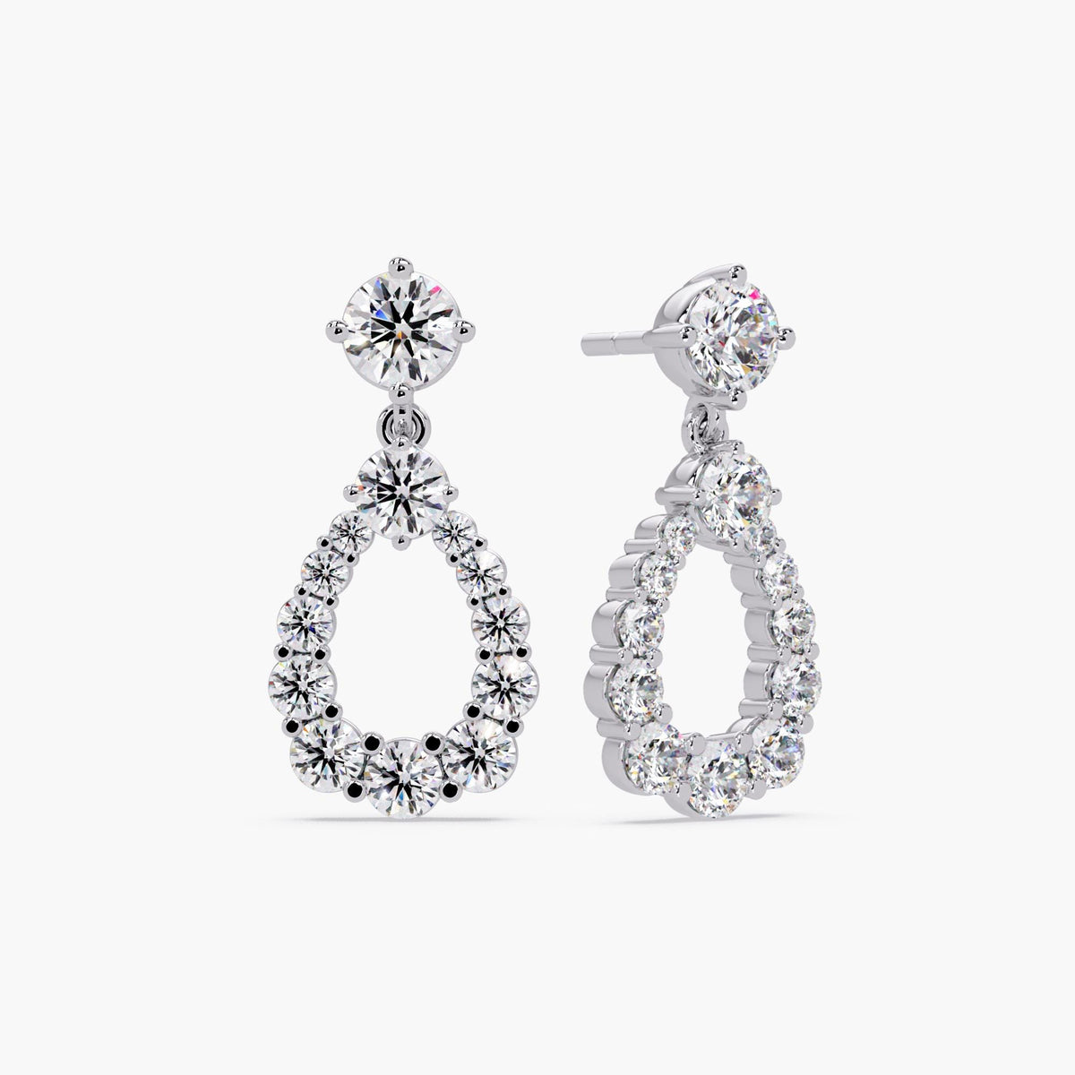 Close-up of gold teardrop diamond dangle earrings with sparkling lab-grown stones