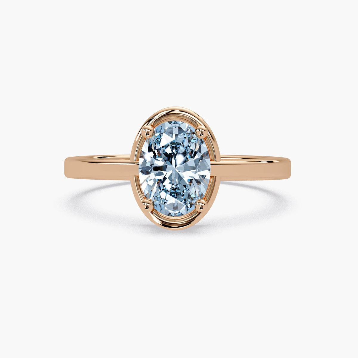 Oval sky blue topaz ring in 14K rose gold highlighting the chunky half-bezel design.