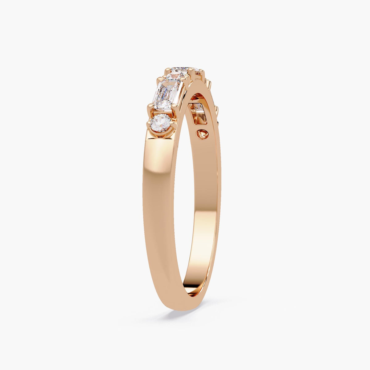 rose gold emerald and round diamond ring showing slim shank