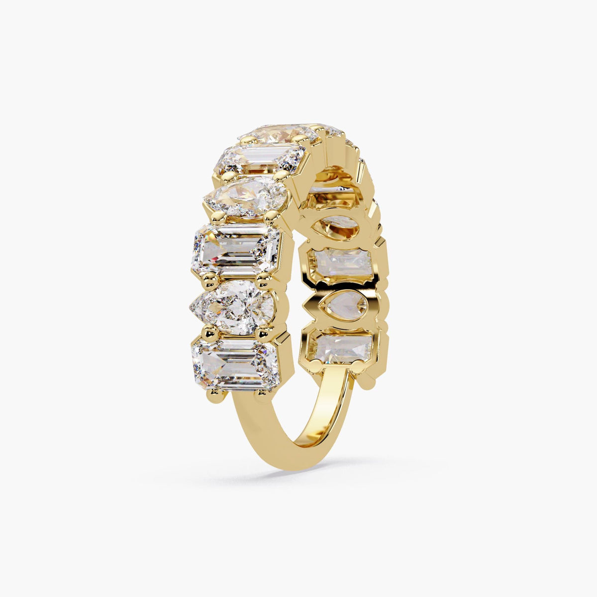 emerald and pear cut lab grown diamonds in a yellow gold 3/4 eternity band.