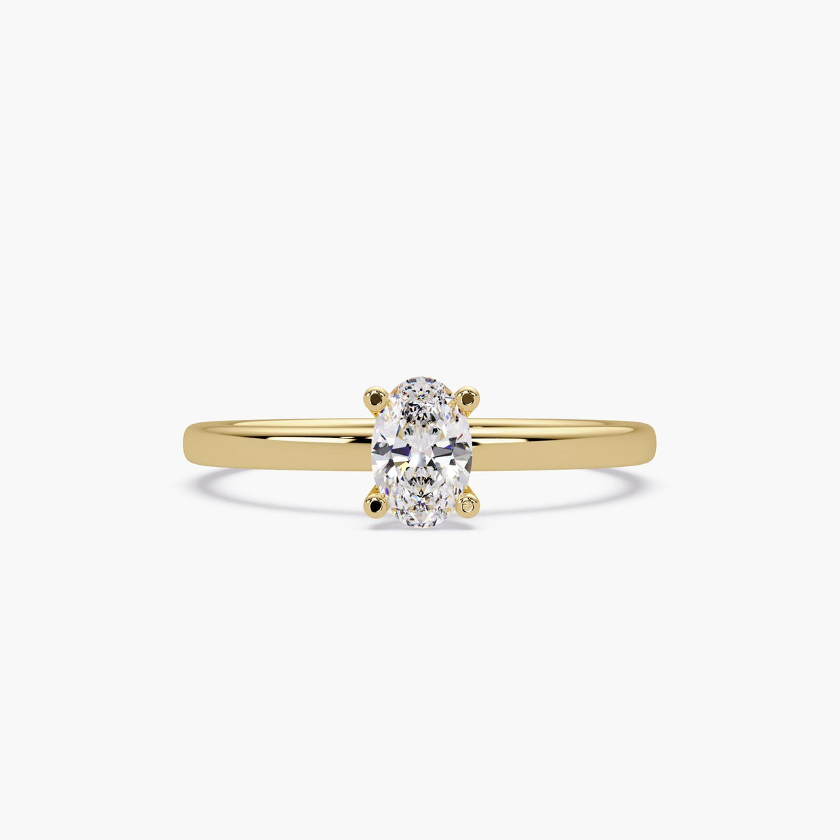 Oval lab grown diamond solitaire ring in 14K yellow gold with a slim polished band and four-prong setting.