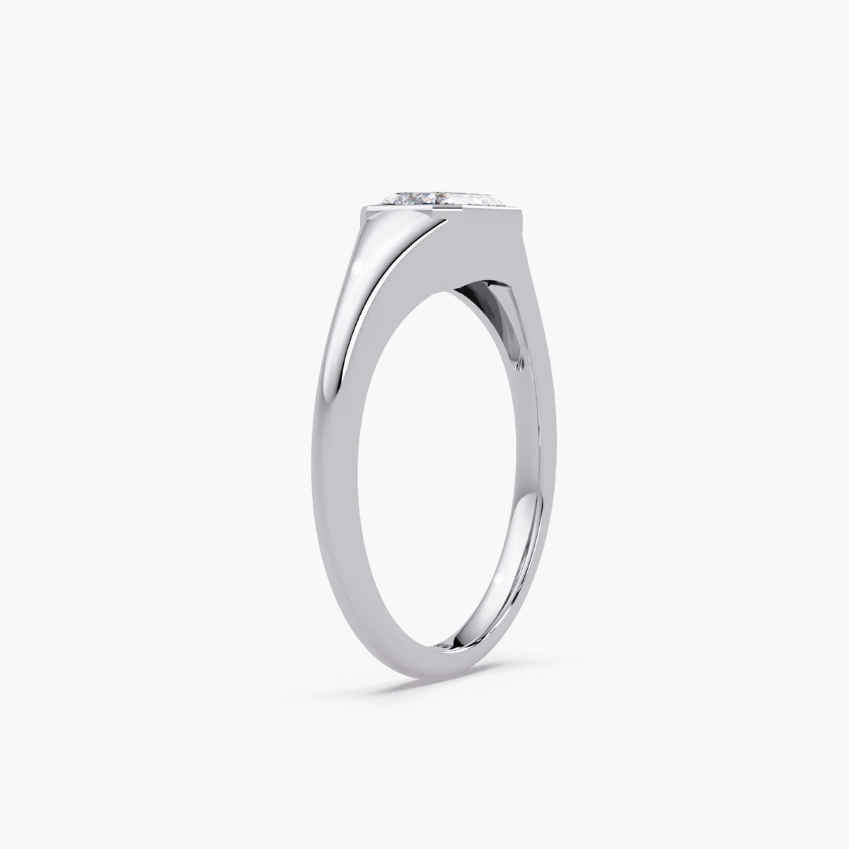Emerald cut lab diamond signet ring in 14K white gold with a bezel-set center stone and smooth tapered band, styled as a modern pinky or statement ring for everyday wear.