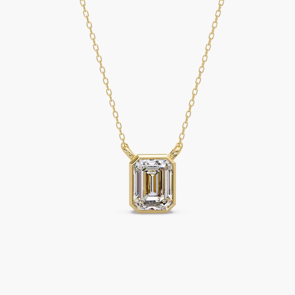 14K yellow gold emerald cut lab grown diamond bezel pendant necklace, 1.5 carat IGI certified diamond on a fine gold cable chain.