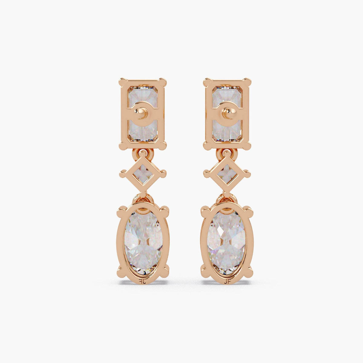 Oval and emerald cut lab grown diamond drop earrings in 14K gold, featuring a graduated three stone design with oval diamonds and emerald accents.