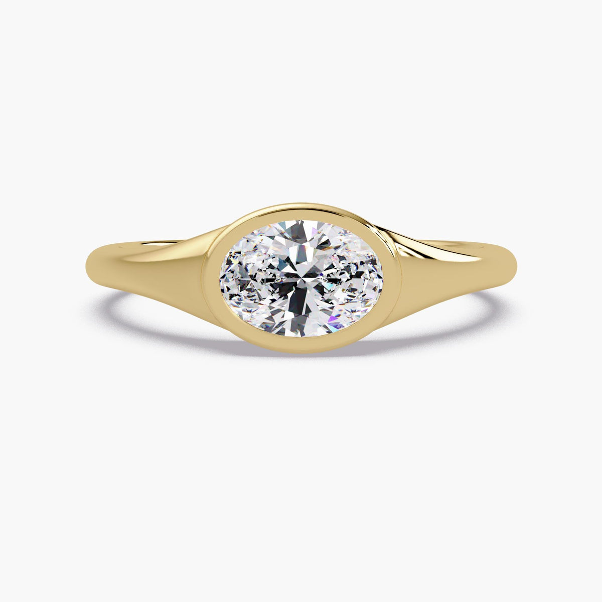 14K yellow gold bezel set oval lab diamond ring with a smooth tapered band, a minimalist diamond pinky ring that can also be worn as an everyday stackable ring, promise ring, or modern engagement ring.